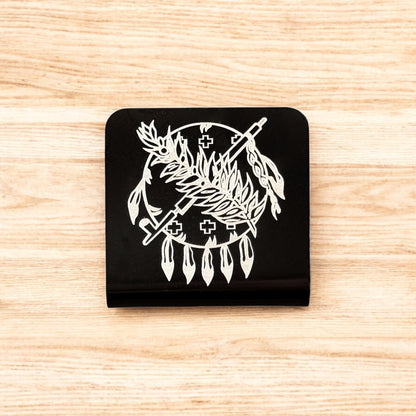 Flat lay of aluminum Oklahoma symbol hat clip showing square shape, black powder coat, and detailed engraved design