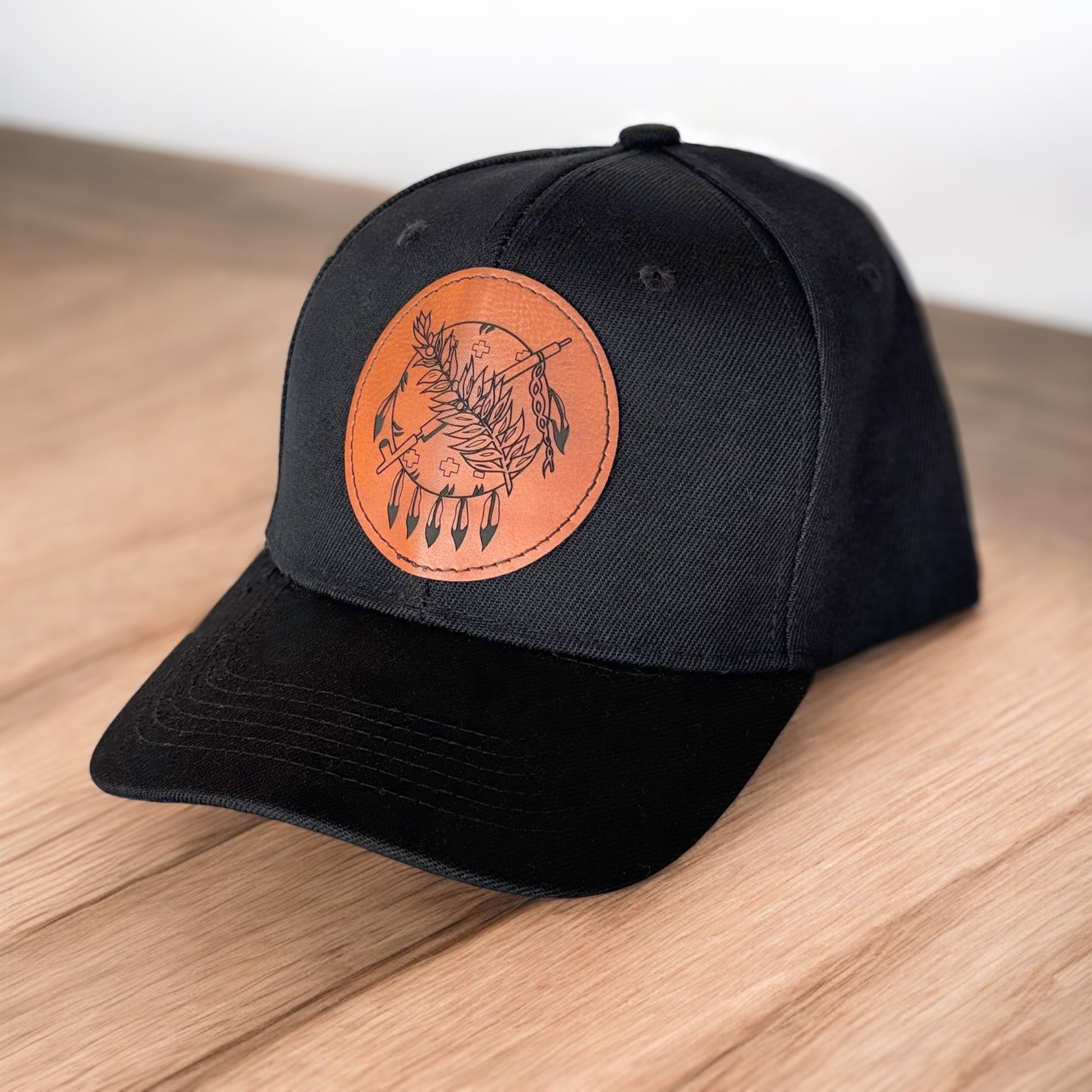 Angled view of black Oklahoma symbol hat with round leatherette patch, minimalist Oklahoma trucker cap