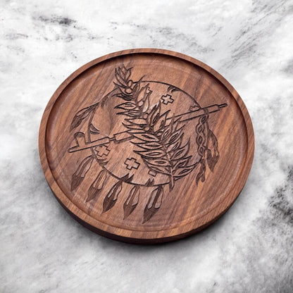 Angled view of round walnut tray with laser engraved Oklahoma emblem showing raised edge and natural walnut grain