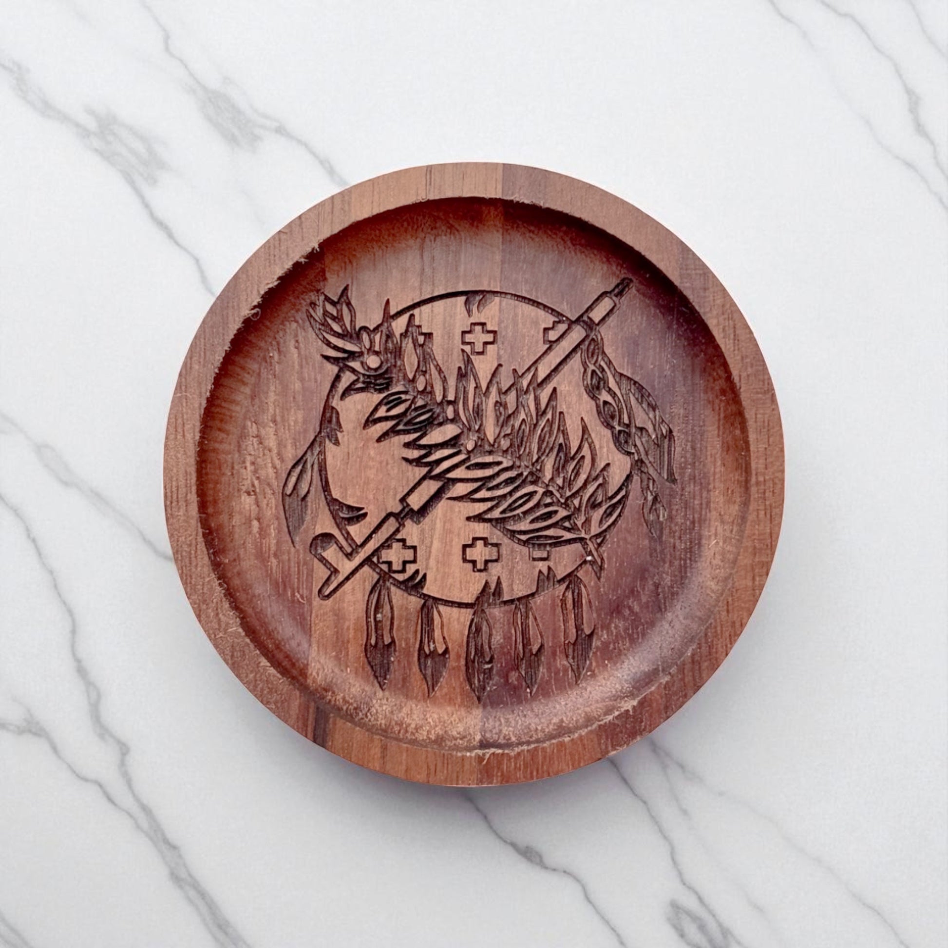 Top down flat lay of an Oklahoma walnut ring tray on a light surface, laser engraved wooden dish used as a ring holder or desk catchall