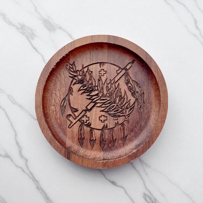 Top down flat lay of an Oklahoma walnut ring tray on a light surface, laser engraved wooden dish used as a ring holder or desk catchall