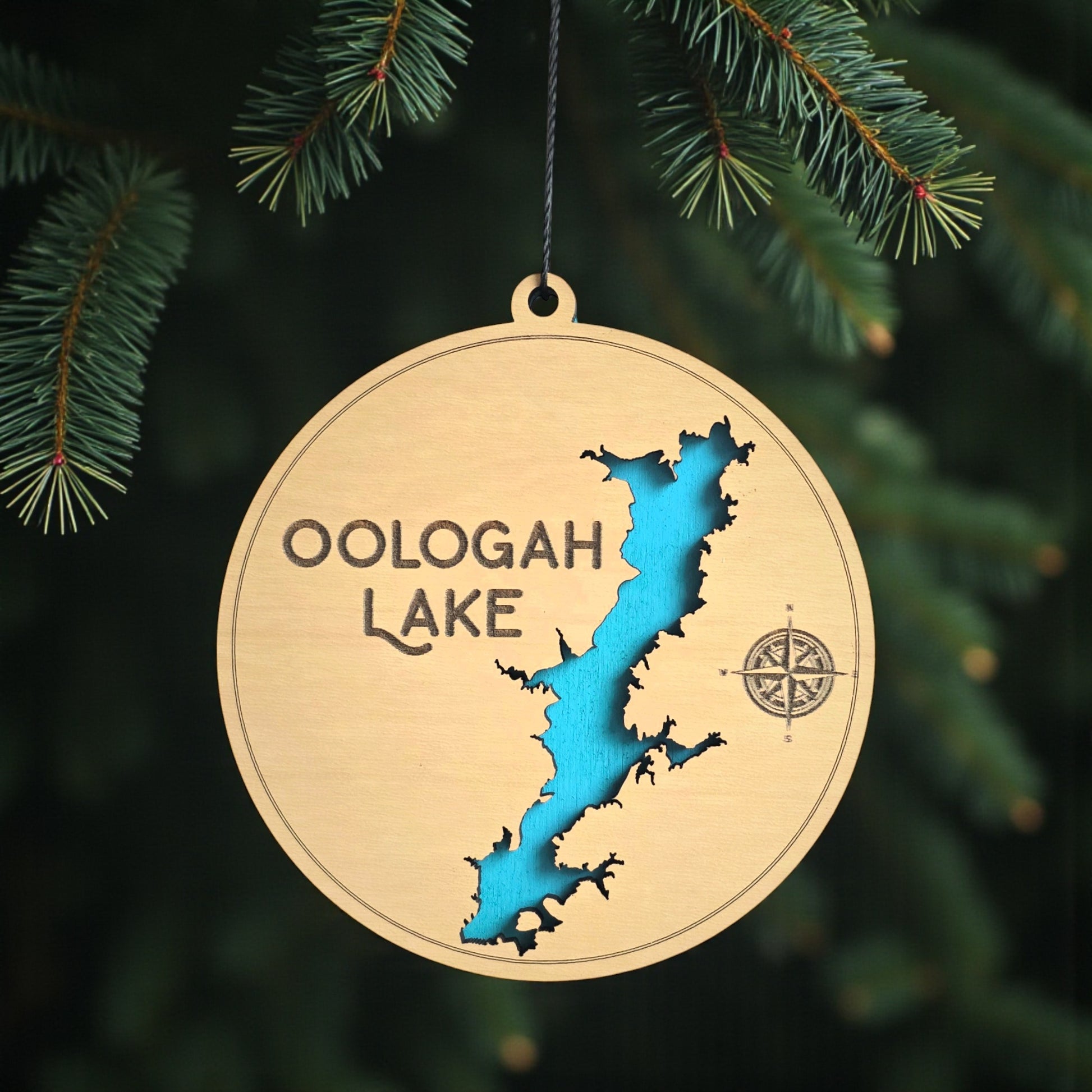 Oologah Lake wooden ornament hanging on evergreen tree, layered wood lake map ornament with blue painted water detail and hanging cord