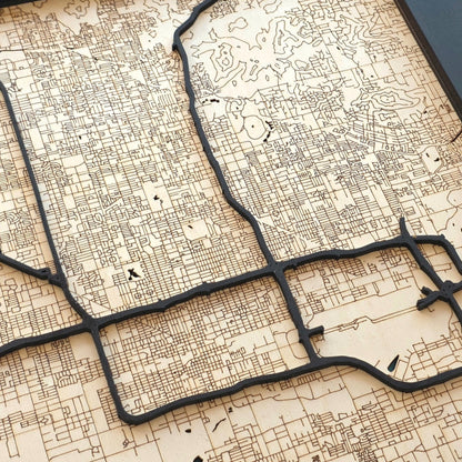 close up of Phoenix wood map showing detailed engraved streets and raised road layers with natural wood tones and dark contrast
