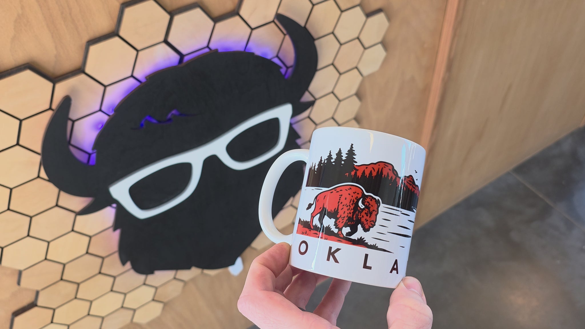Video showing off the 11oz coffee mug rotating around. Oklahoma wildlife coffee mug featuring canoe paddler on lake at sunrise with mountain silhouette and forest landscape, Oklahoma souvenir mug with outdoor adventure theme