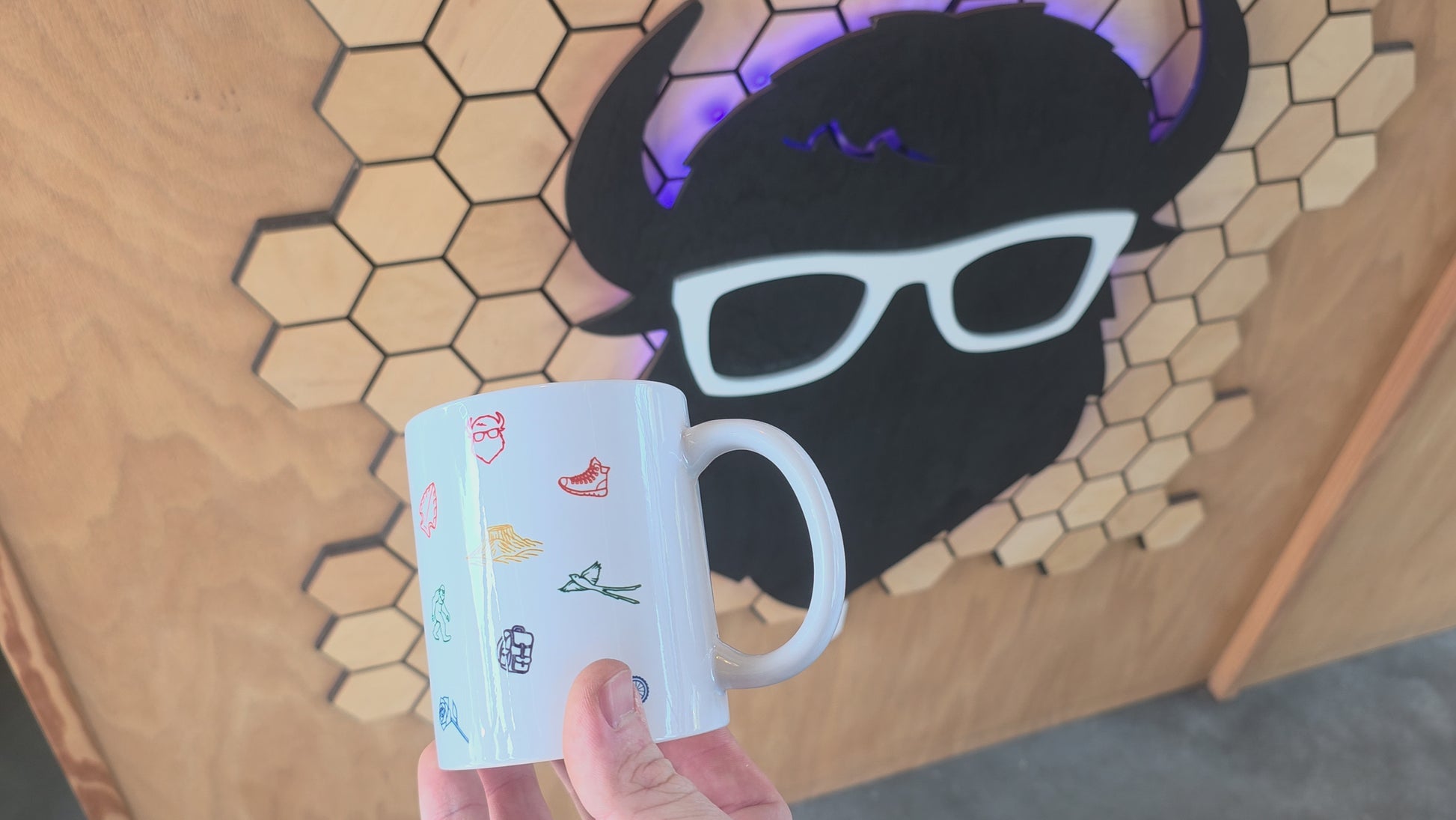 ceramic coffee mug with colorful Oklahoma icons including bison, rose, scissortail, and Gloss Mountains.