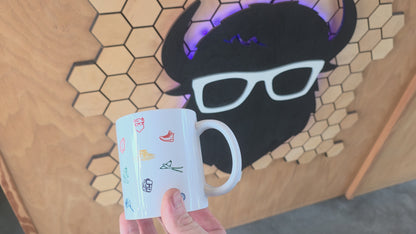 ceramic coffee mug with colorful Oklahoma icons including bison, rose, scissortail, and Gloss Mountains.