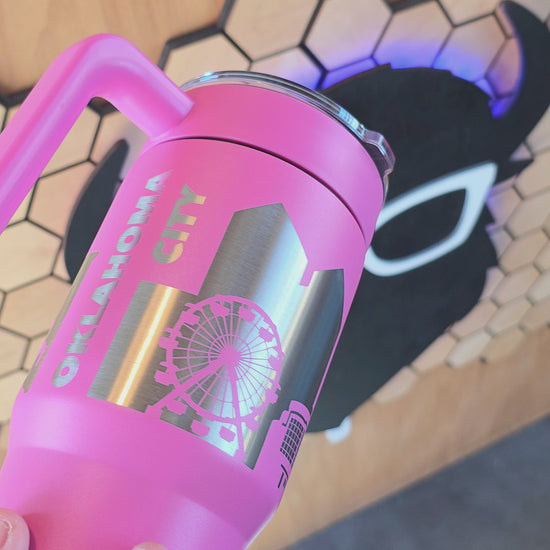 video showing Pink Oklahoma City Skyline 30oz tumbler with handle and laser-engraved stainless design, stylish OKC souvenir by The Curious Bison.