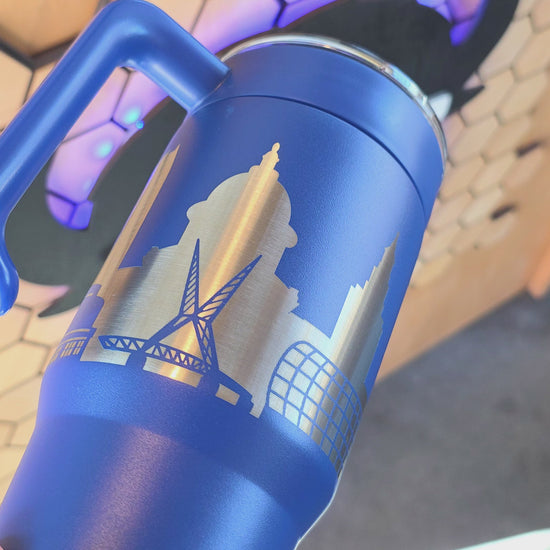 Video showing Blue Oklahoma City Skyline 30oz handle tumbler with engraved stainless city design, OKC travel mug by The Curious Bison.