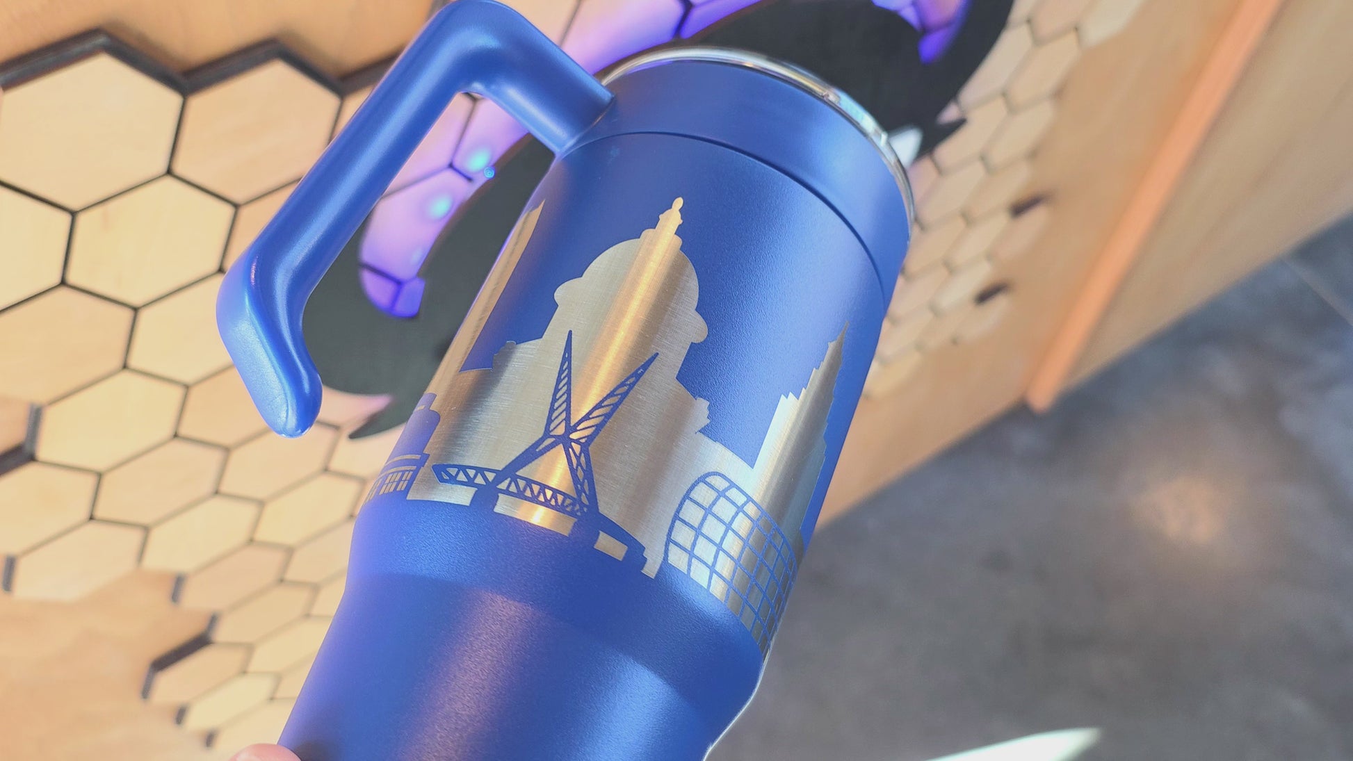 Video showing Blue Oklahoma City Skyline 30oz handle tumbler with engraved stainless city design, OKC travel mug by The Curious Bison.