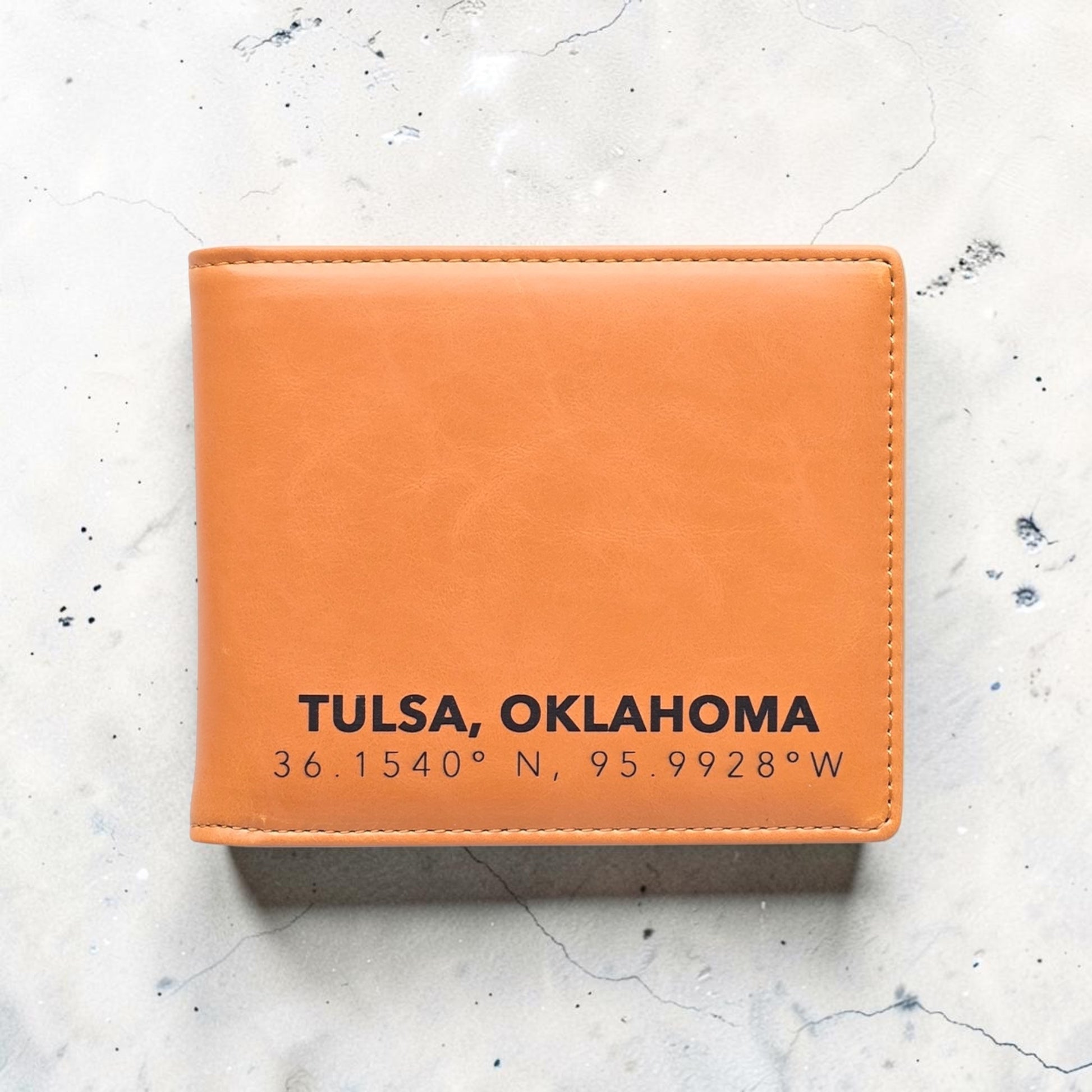 RFID Wallet Tulsa Oklahoma Coordinates Mens Bifold displayed on stone background with stitched leatherette finish, practical Tulsa gift wallet with hometown coordinates design
