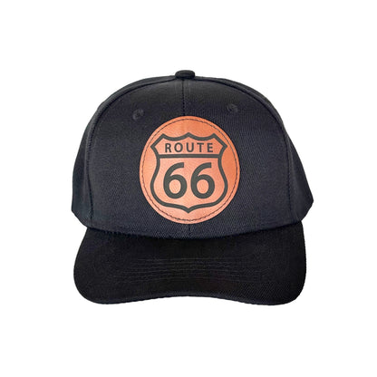 Route 66 leather patch hat with black front panels, curved bill trucker hat featuring classic Route 66 shield patch