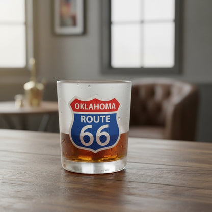 Oklahoma Route 66 8 oz whiskey lowball glass filled with an amber drink on a wood table, showing the red, white, and blue Route 66 shield as a home bar and travel souvenir