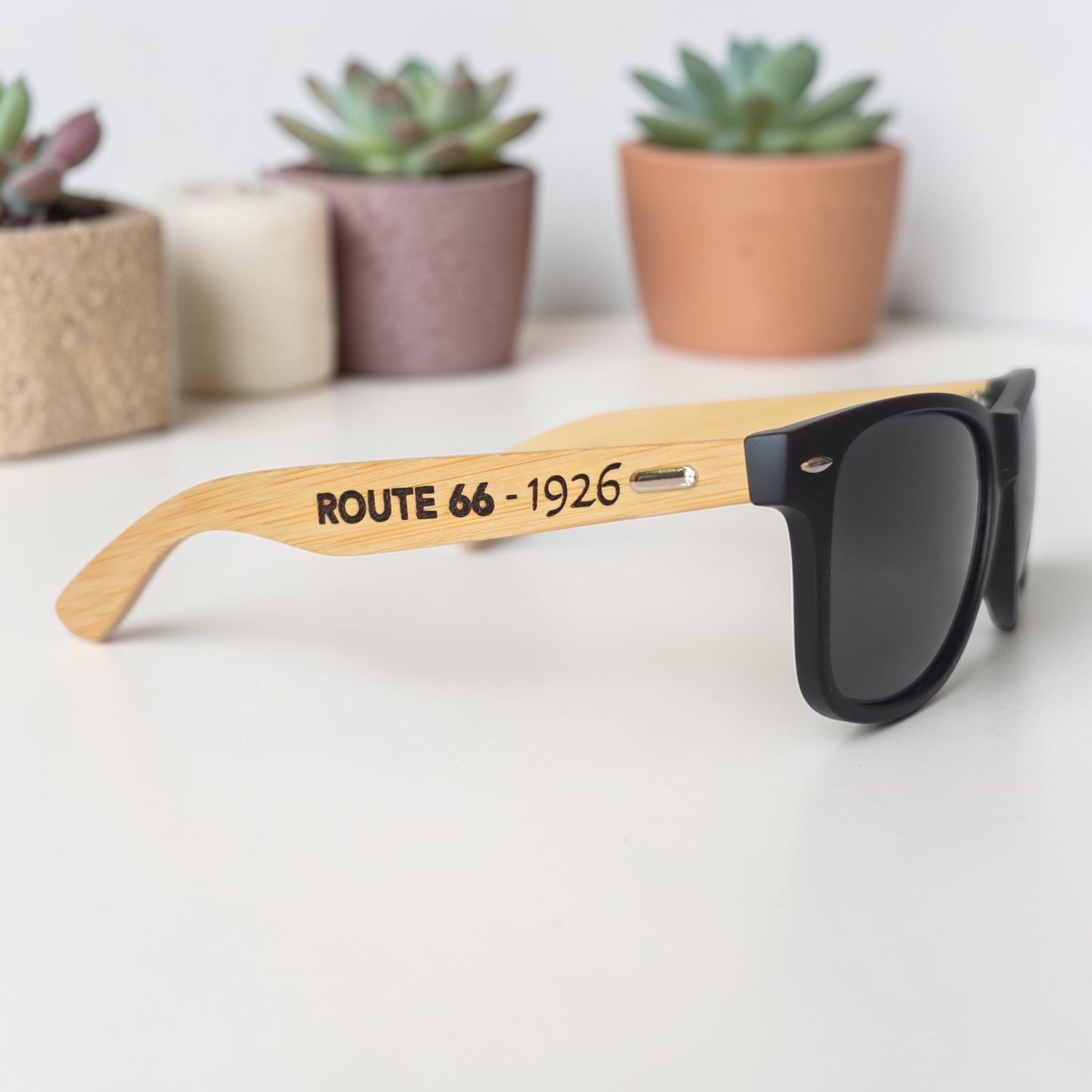 Side profile of Route 66 engraved bamboo sunglasses with black lenses and black frame, souvenir sunglasses for travelers exploring historic Route 66