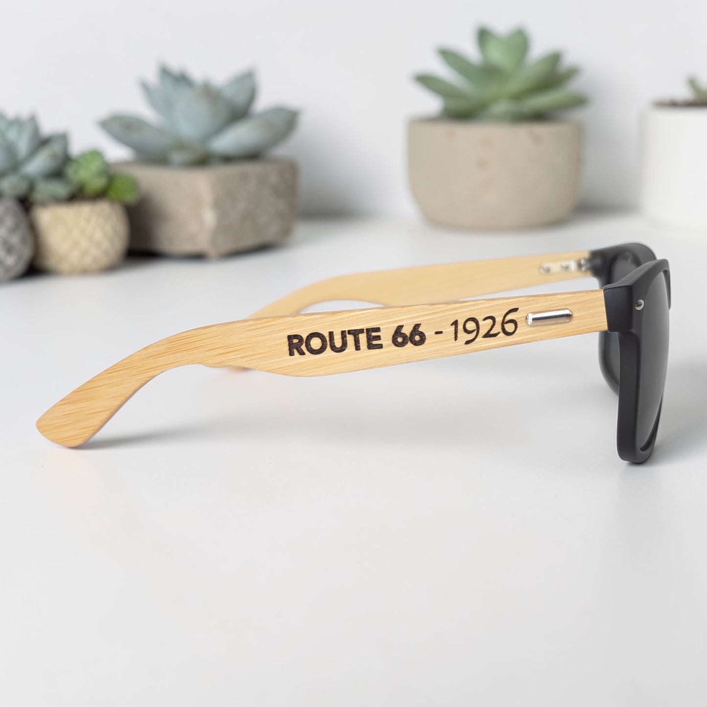 Stylish black sunglasses with natural bamboo wood arms engraved with Route 66 text, unique gift idea for road trippers and Route 66 collectors