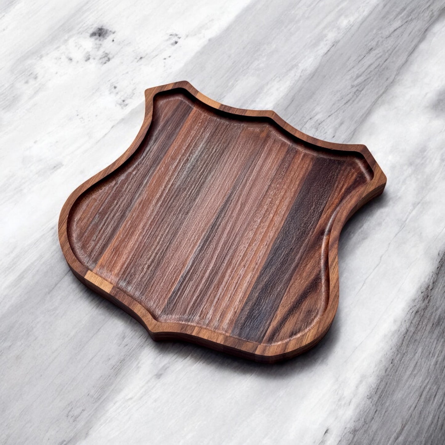 Angled view of Route 66 walnut catch all tray showing recessed edge and walnut grain, badge shaped wood tray for keys and small items, Route 66 souvenir gift