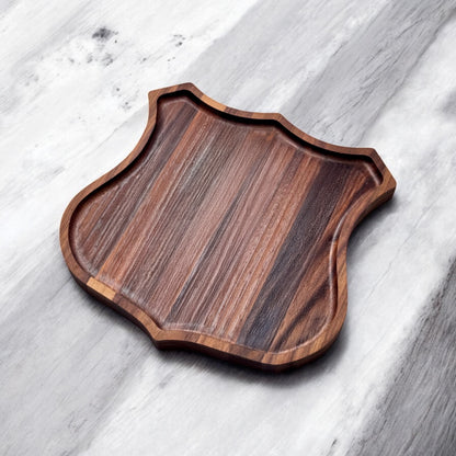 Angled view of Route 66 walnut catch all tray showing recessed edge and walnut grain, badge shaped wood tray for keys and small items, Route 66 souvenir gift