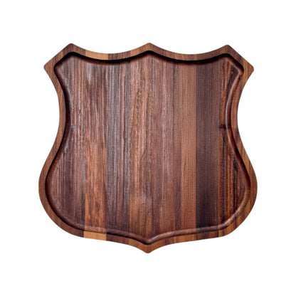 Route 66 walnut catch all tray in badge shape shown from above, solid walnut wood tray with recessed edge, travel themed desk or entryway organizer gift made in the USA