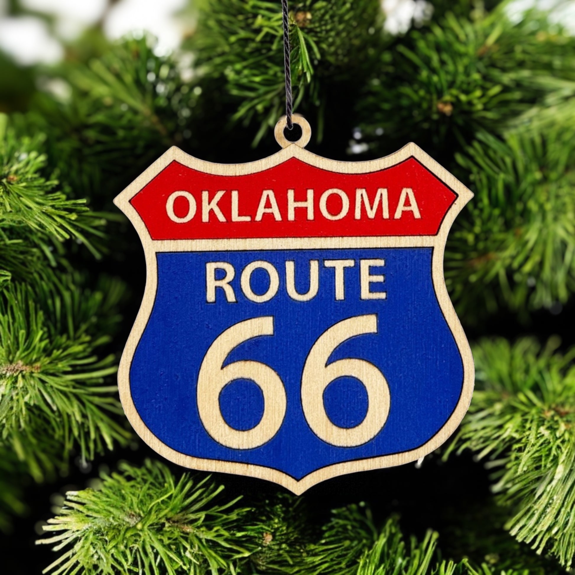 Route 66 wooden ornament hanging on evergreen tree, Oklahoma Route 66 shield ornament used as Christmas decor or travel keepsake