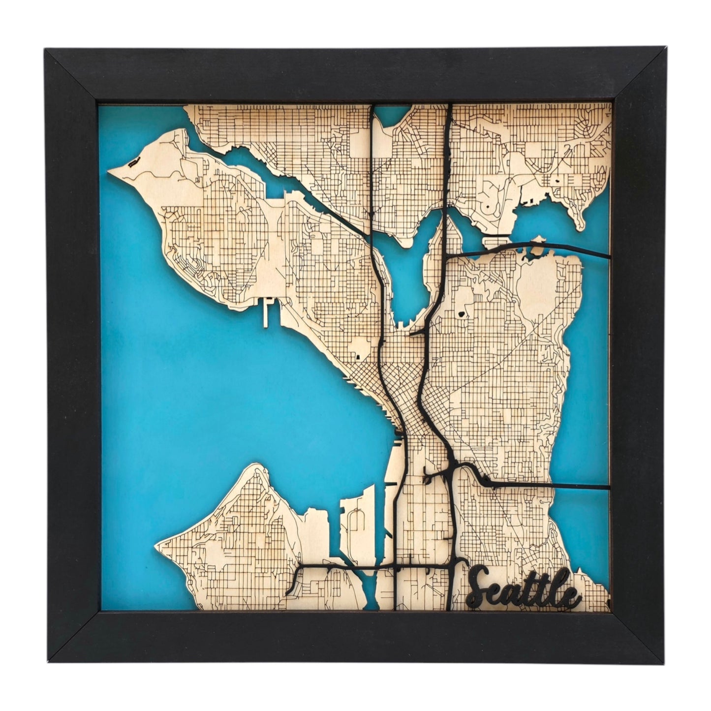framed Seattle wooden city map wall art with layered wood streets and blue water background, detailed laser cut Seattle map decor for home or travel souvenir