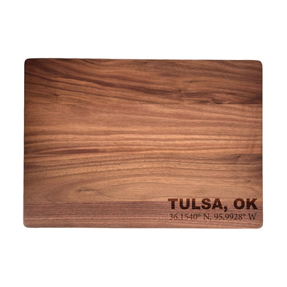 Walnut cutting board engraved with Tulsa Oklahoma coordinates, solid wood board with rich grain and clean rectangular shape