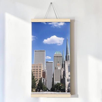 Tulsa Oklahoma canvas wall art hanging on a white wall, featuring a vertical Boston Avenue downtown skyline photograph with natural wood scroll rails and hanging cord