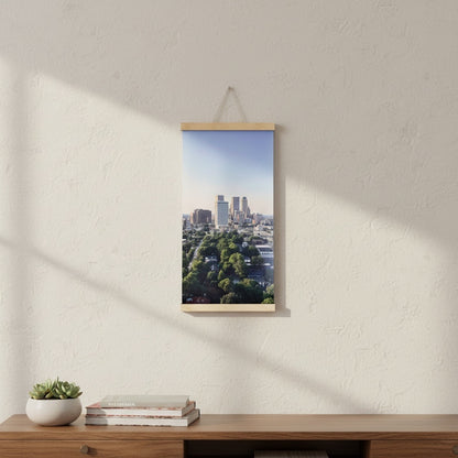 Downtown Tulsa skyline canvas wall art hanging on a white wall, featuring original Oklahoma cityscape photography in a vertical 12 x 24 inch format with wood rails
