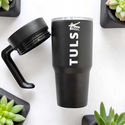 Black Tulsa Driller 30oz tumbler with detachable handle and lid shown separately, stainless steel insulated Tulsa drinkware