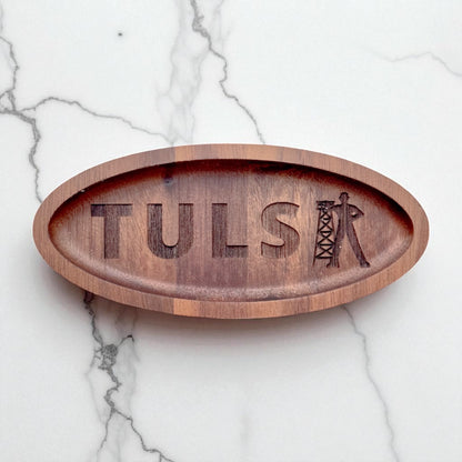 Flat lay of a Tulsa Driller walnut ring tray on a light surface, laser engraved wooden dish used as a ring holder or desk catchall