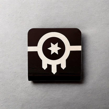 Square aluminum hat clip with Tulsa flag design displayed against a neutral background showing engraved lines and contrast