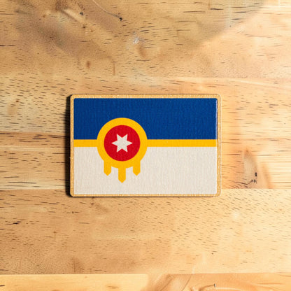 Back side of Tulsa wooden lapel pin showing secure rubber backing on Eco Wood Birch souvenir pin