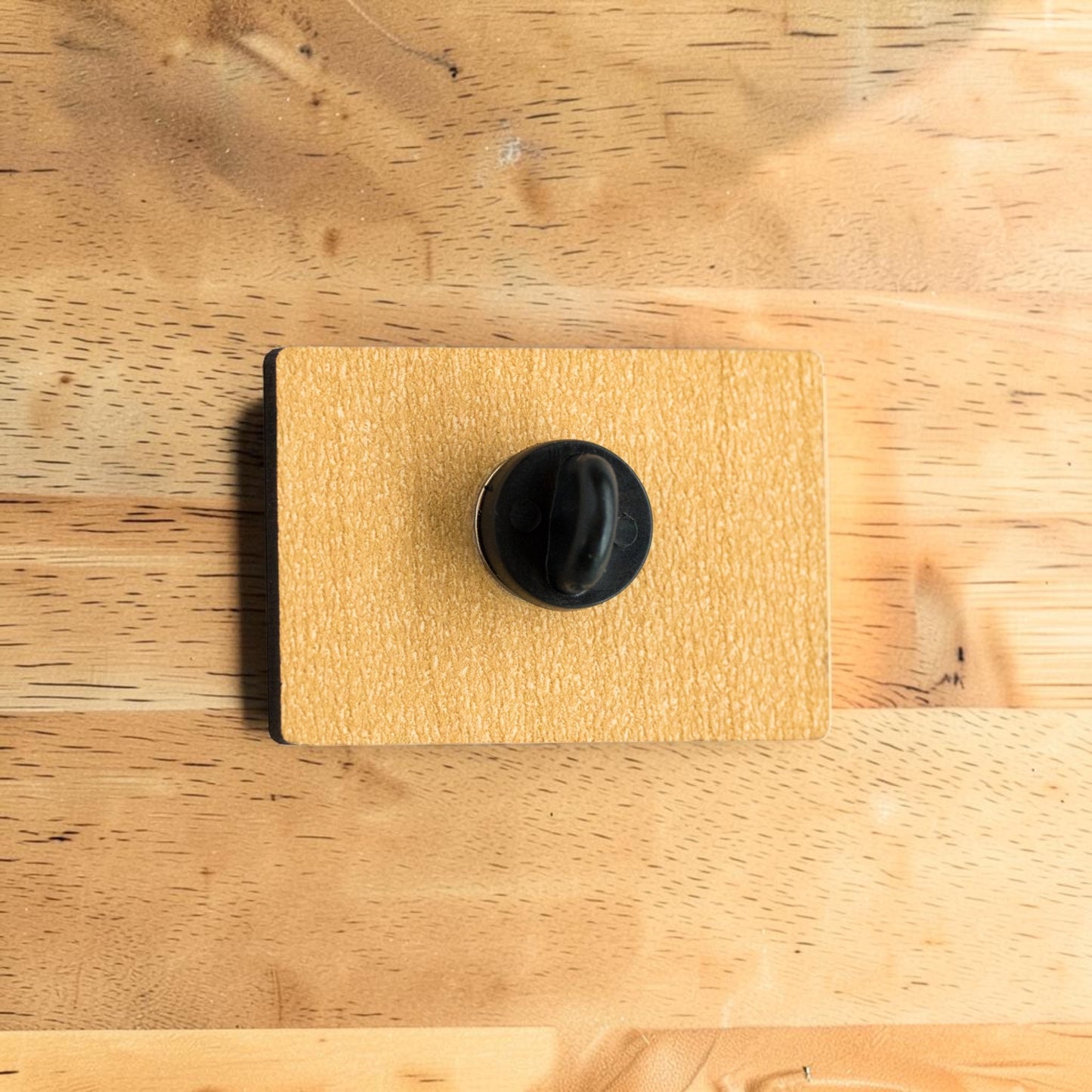 Tulsa flag lapel pin made from Eco Wood Birch featuring official Tulsa city flag design displayed on wood table