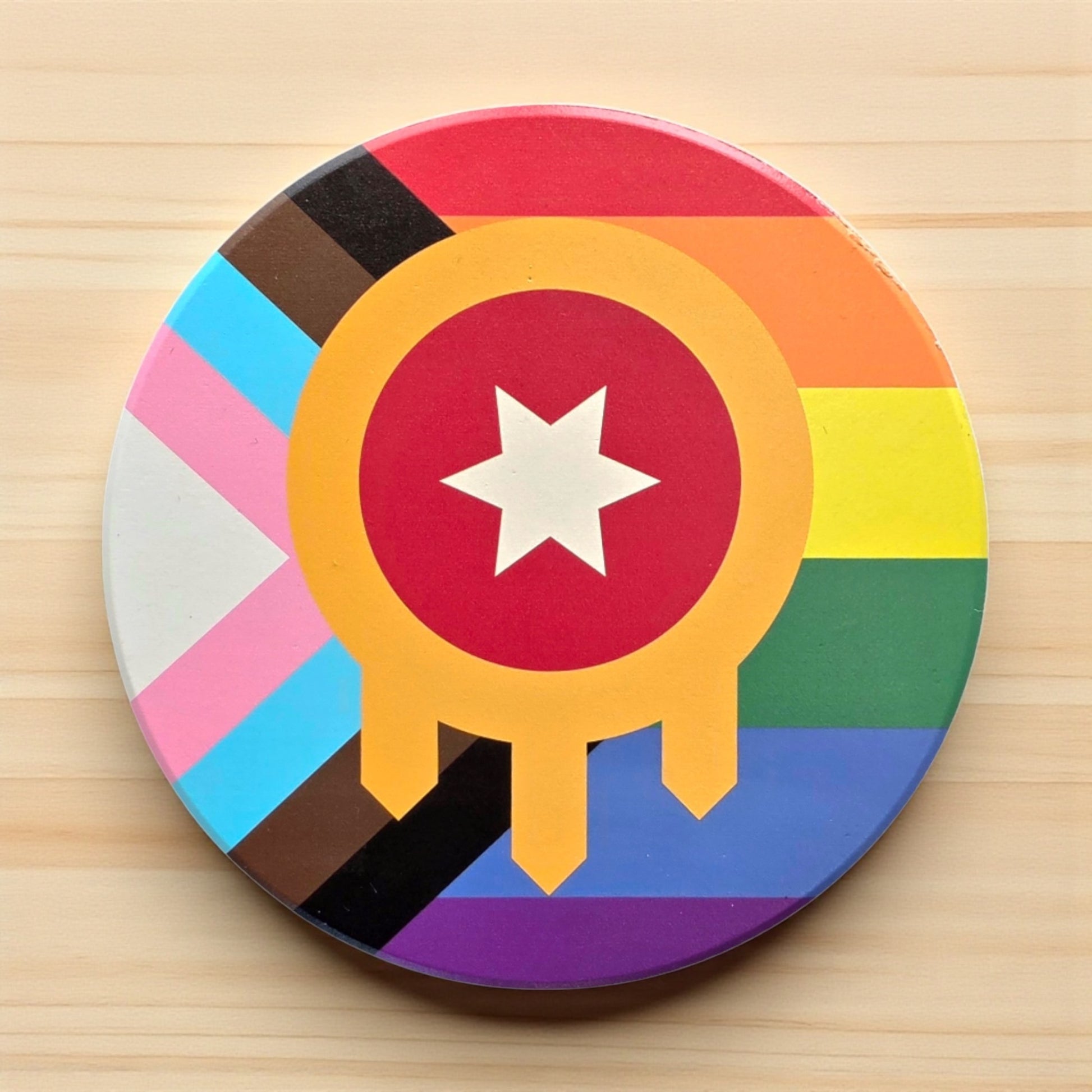 Tulsa flag inclusive Pride ceramic coaster displayed on a wood surface, round ceramic Tulsa pride coaster used as an Oklahoma gift