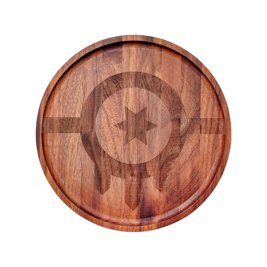 Top-down image of round walnut serving board with laser-engraved modern Tulsa flag design
