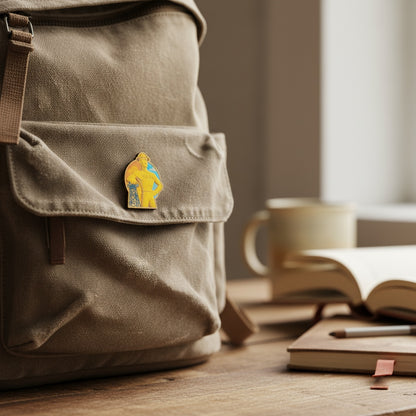 Tulsa Golden Driller lapel pin made from Eco Wood Birch featuring iconic Tulsa landmark statue design on wood table