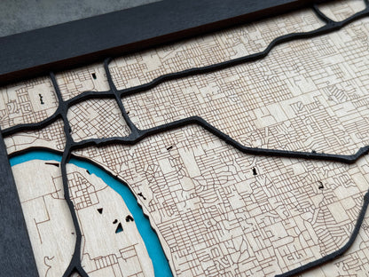 Close up of raised black road layers on Tulsa wooden city map, showing laser cut roads and engraved neighborhood detail