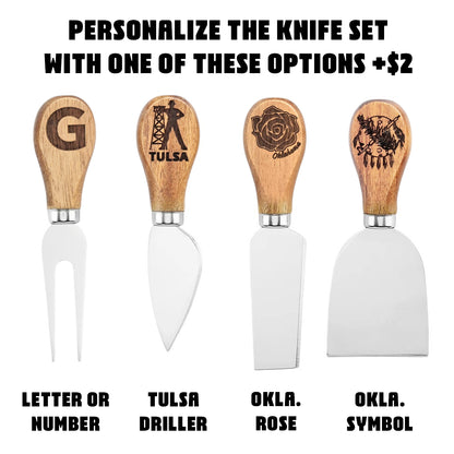 Four cheese knives with engraved handle personalization options shown beside Tulsa Oklahoma marble wood charcuterie board, gift ready serving set with custom add on choices