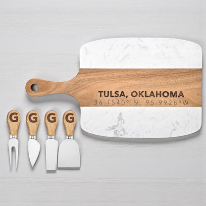 Tulsa Oklahoma engraved charcuterie board displayed with four cheese knives featuring letter monogram handles, marble and acacia wood serving board for personalized gifting