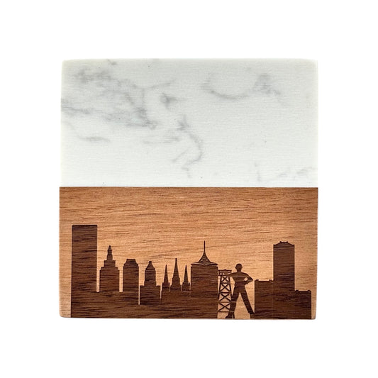 Close-up of a Tulsa Oklahoma skyline coaster made from acacia wood and marble, laser engraved with the Golden Driller and city skyline.