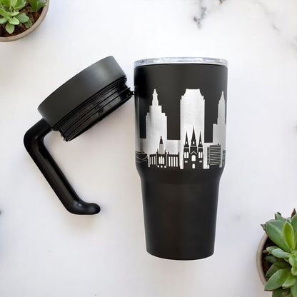 Black Tulsa skyline insulated tumbler flat lay with detachable handle and metallic engraved Tulsa skyline