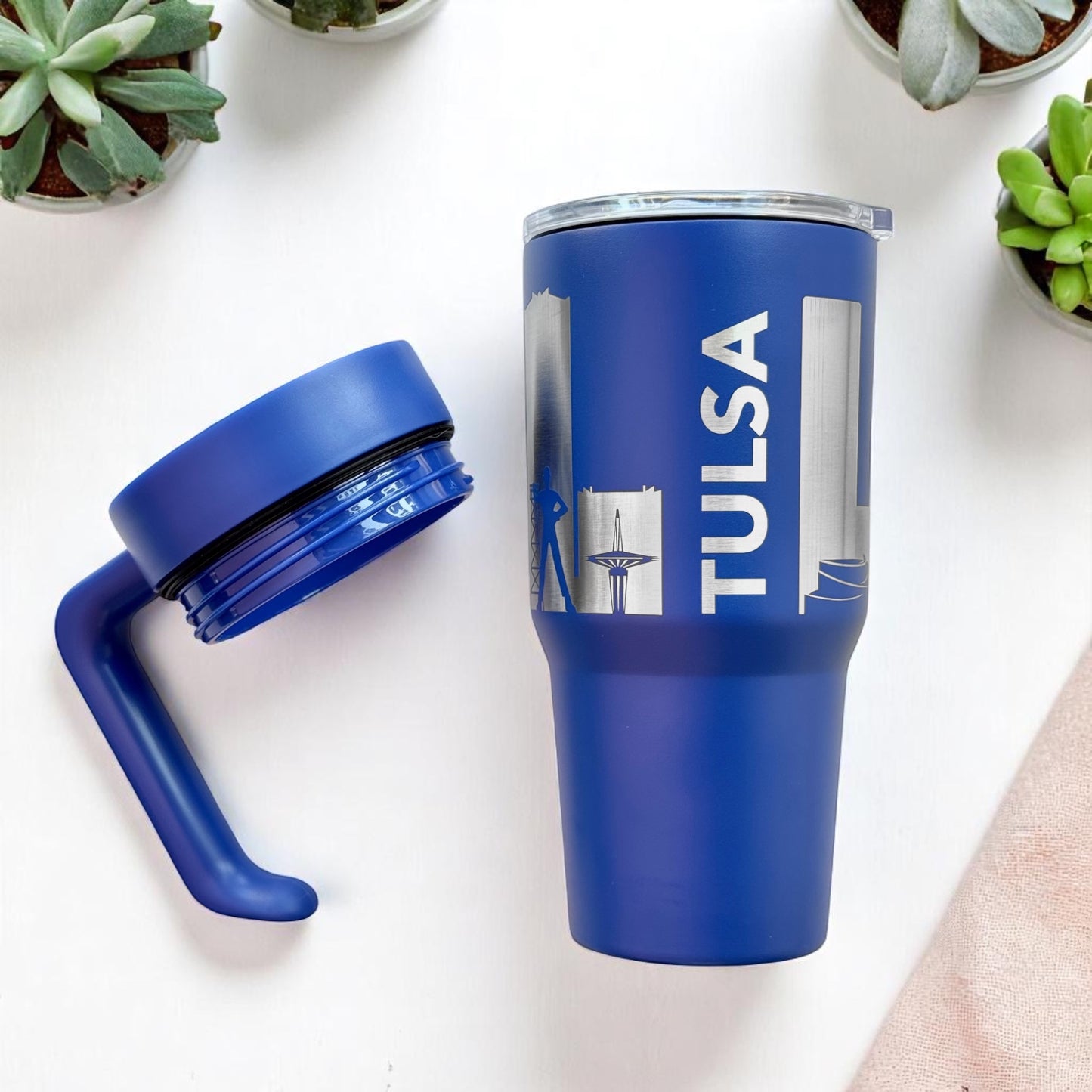 Blue Tulsa skyline insulated tumbler with detachable handle removed, showing stainless steel lid and engraved Tulsa city skyline design