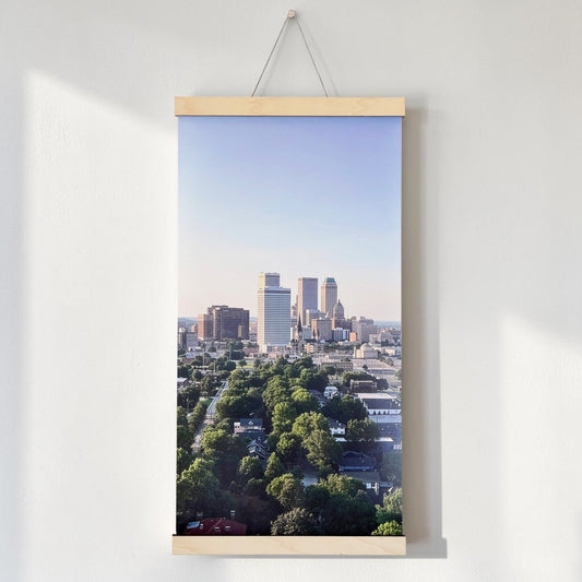 Tulsa skyline canvas wall hanging displayed above a wood console, showing an elevated view of downtown Tulsa and surrounding green neighborhoods as Oklahoma home decor