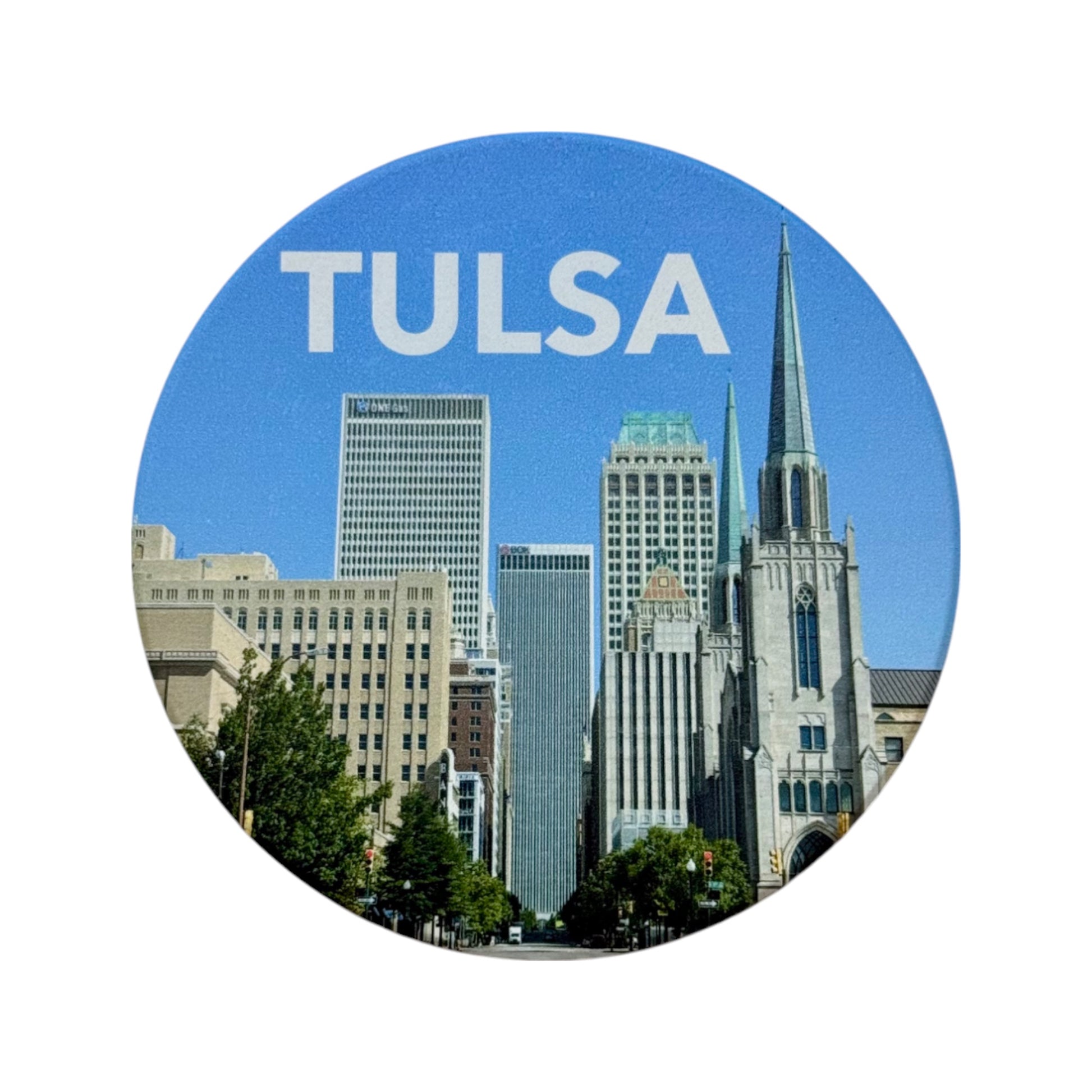 Round Tulsa skyline ceramic coaster showing downtown Tulsa along Boston Avenue with blue sky, Oklahoma souvenir coaster for home or office use.