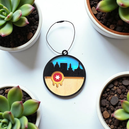 Flat lay of Tulsa flag skyline wooden ornament on white surface with plants, layered wood Tulsa skyline ornament for Oklahoma gift or travel souvenir