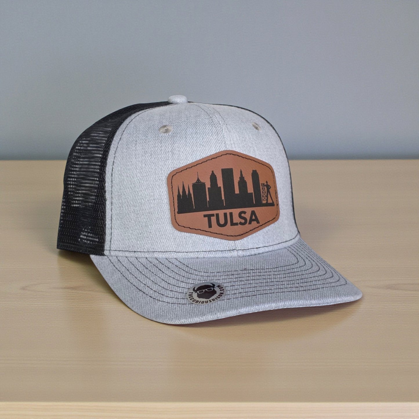 Side view of Tulsa skyline trucker hat showing black mesh back and adjustable snapback closure