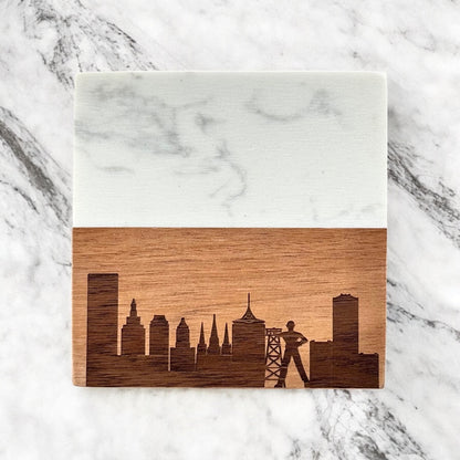 Single Tulsa skyline marble and acacia wood coaster photographed flat lay on marble surface, engraved Tulsa city skyline design