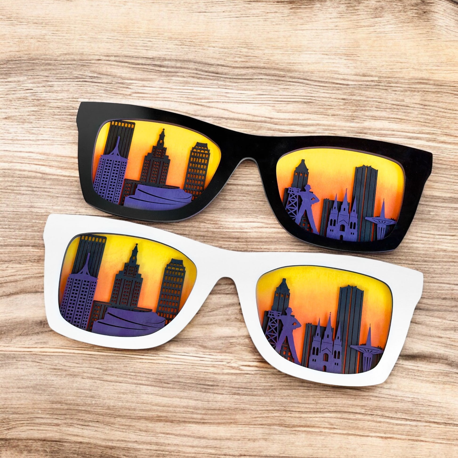 Tulsa skyline sunglasses decor shown in black and white frame options on a wood surface