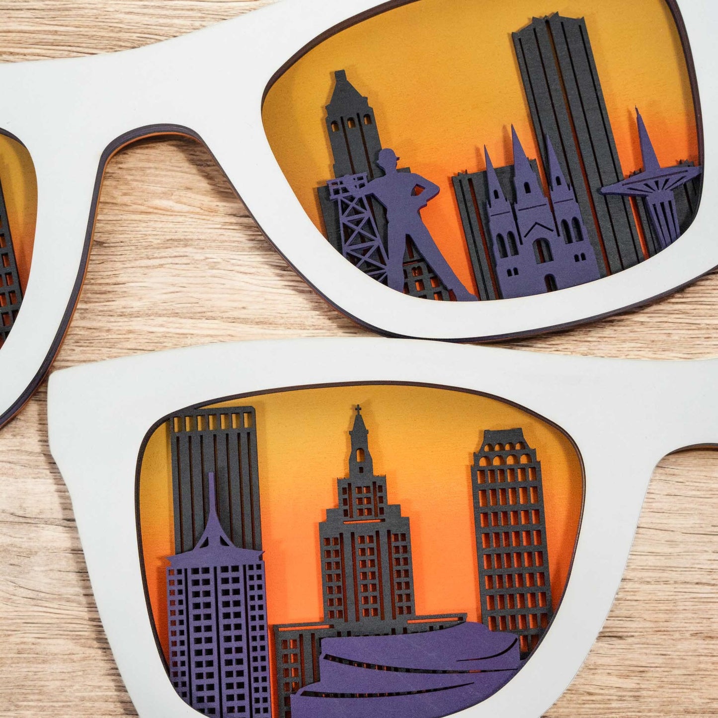 Close up of layered wood Tulsa skyline inside sunglasses showing detailed city buildings and warm sunset colors