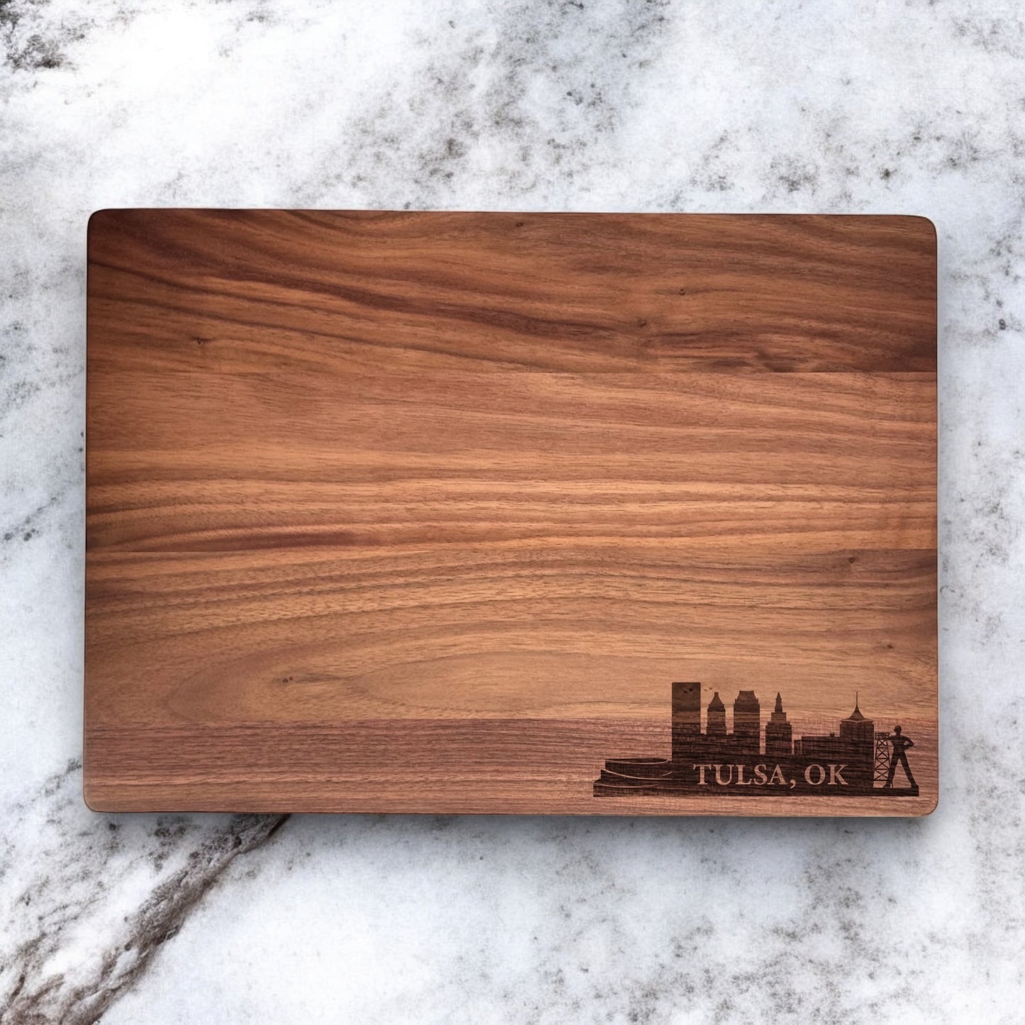 Walnut cutting board engraved with Tulsa skyline design, custom city themed wood serving board