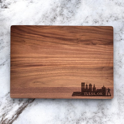Walnut cutting board engraved with Tulsa skyline design, custom city themed wood serving board