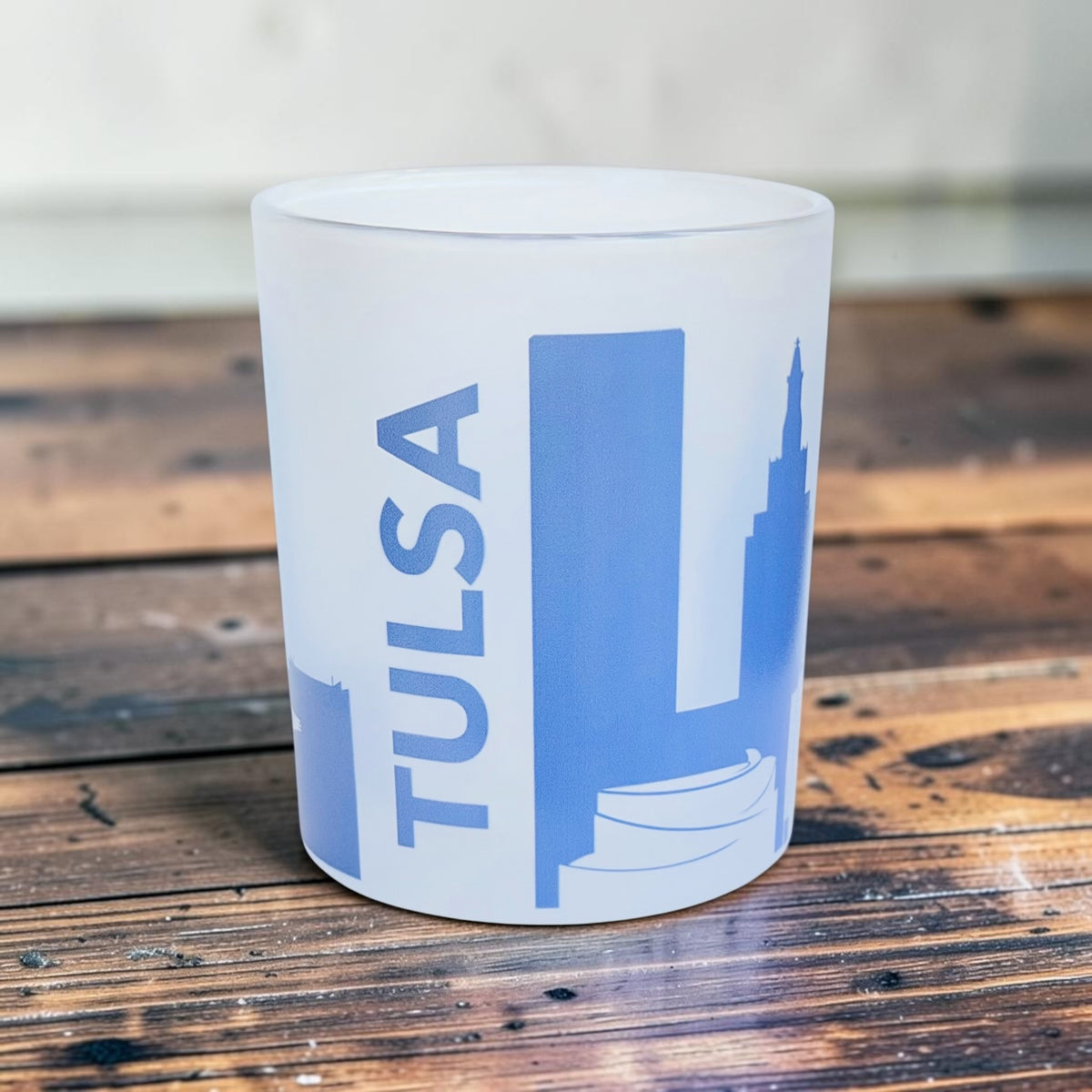 Side view of Tulsa Oklahoma frosted whiskey glass showing the blue wraparound skyline with Golden Driller, downtown buildings, church architecture, and other Tulsa landmarks